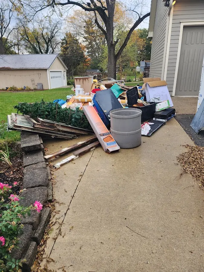 Dumpster being loaded with debris for Estate Cleanout Dumpster Rental in Mont Belvieu
